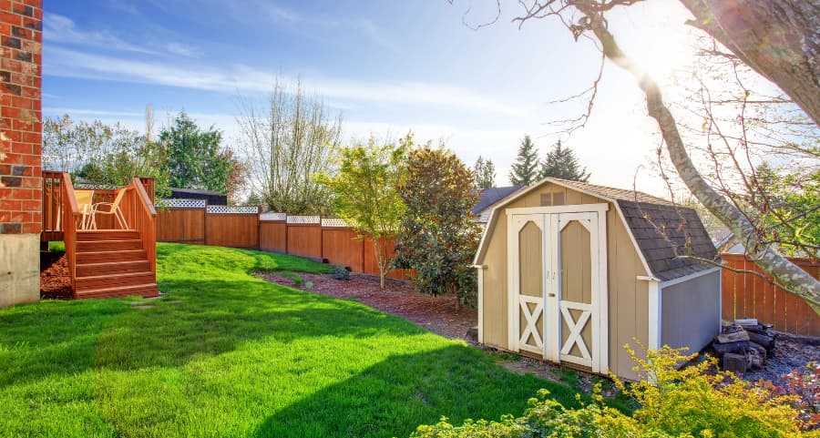 Fenced backyard with storage shed in Jamestown